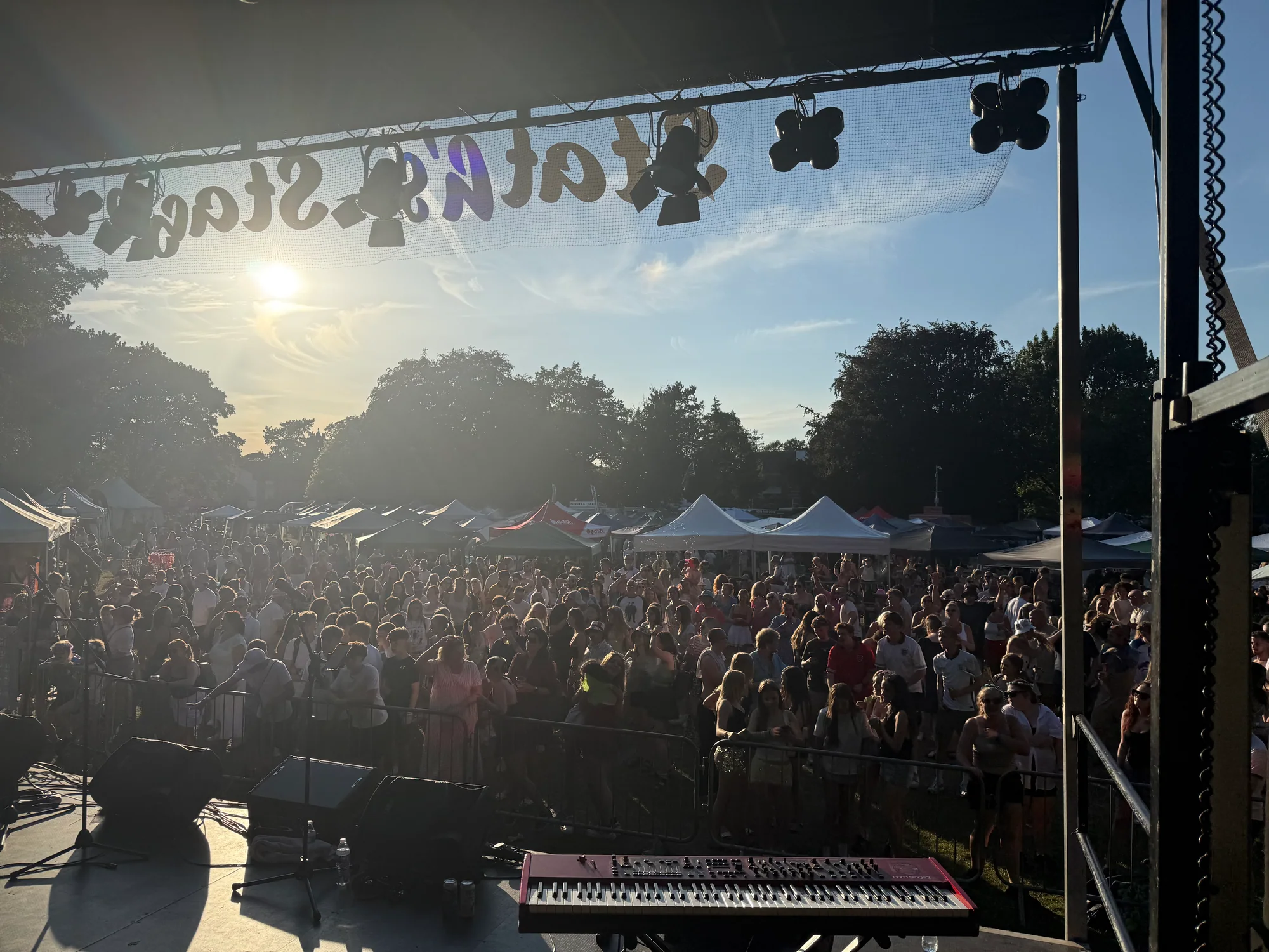 View from the main stage across the audience and festival stalls at Alsager Music Festival