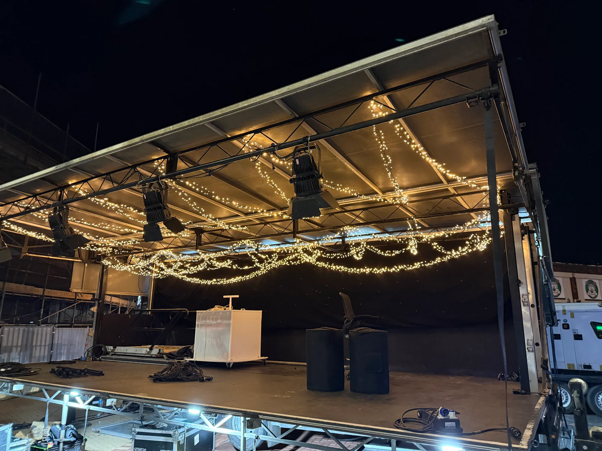 Christmas switch-on trailer stage during takedown with fairy lights still rigged