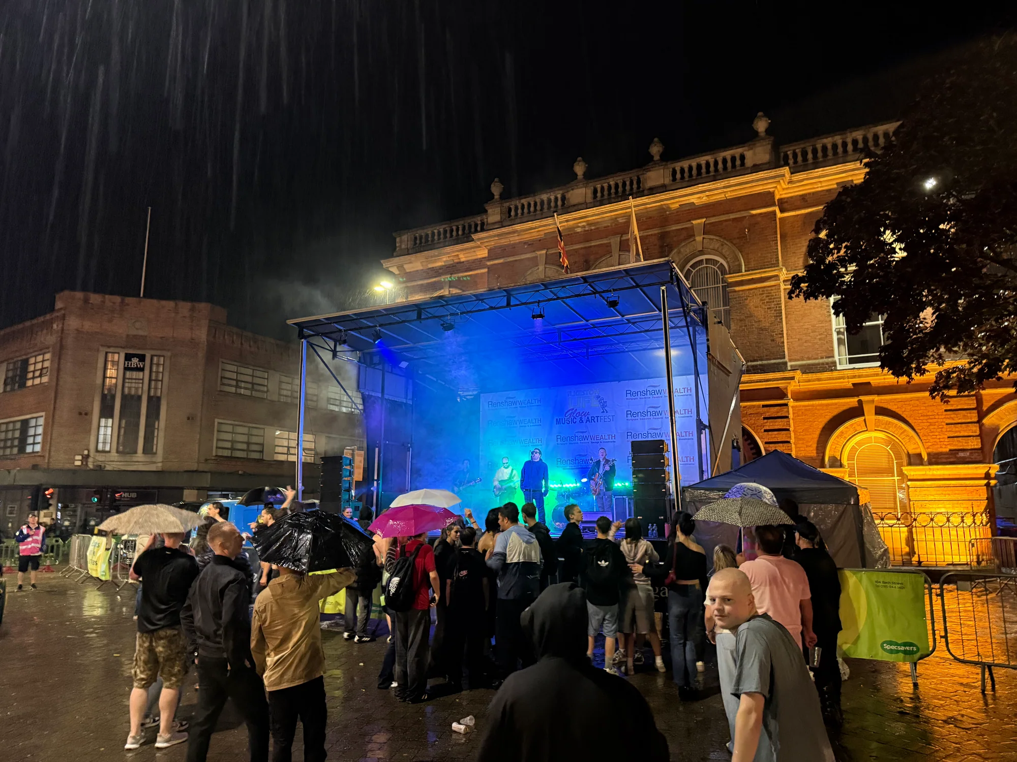 8m x 6m trailer stage and audience in heavy rain at Ilkeston Glow Music and Art Fest