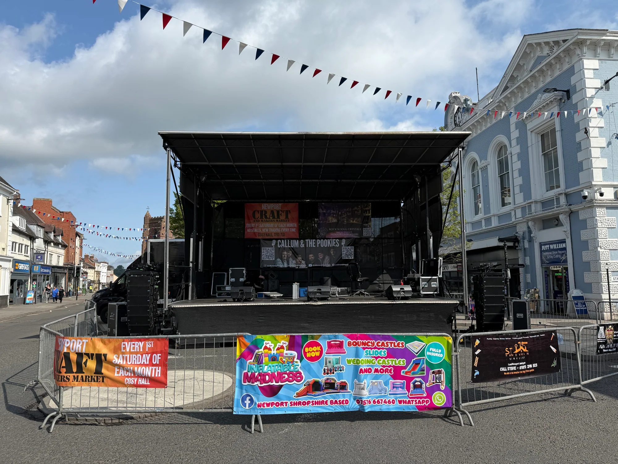 Newport Carnival 2025 stage set up on the High Street mini-roundabout with rear banners