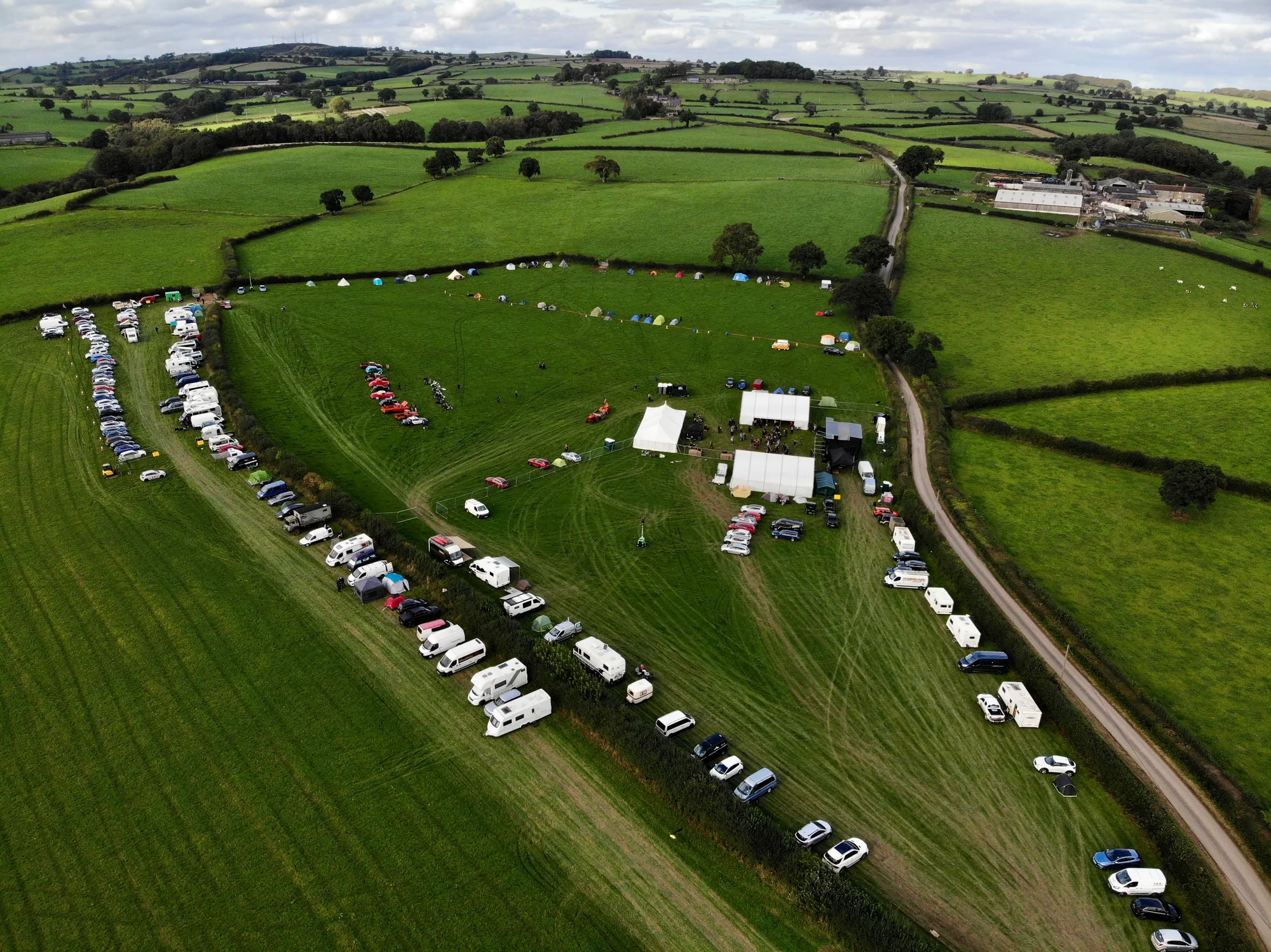 Aerial view of the rural Southern Uprising Festival site during setup in Derbyshire