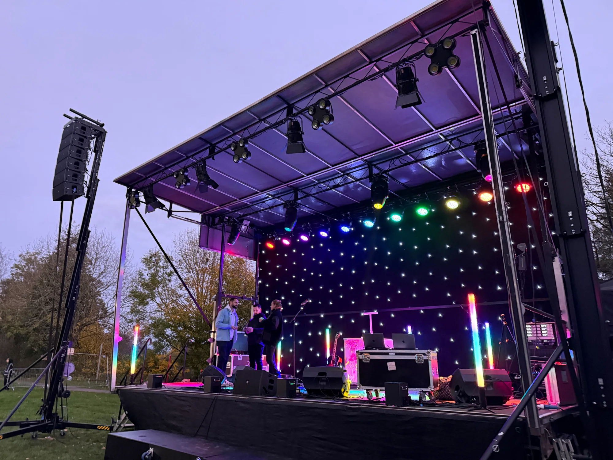 8m x 4m fireworks-night stage set up with lighting and a rear starcloth