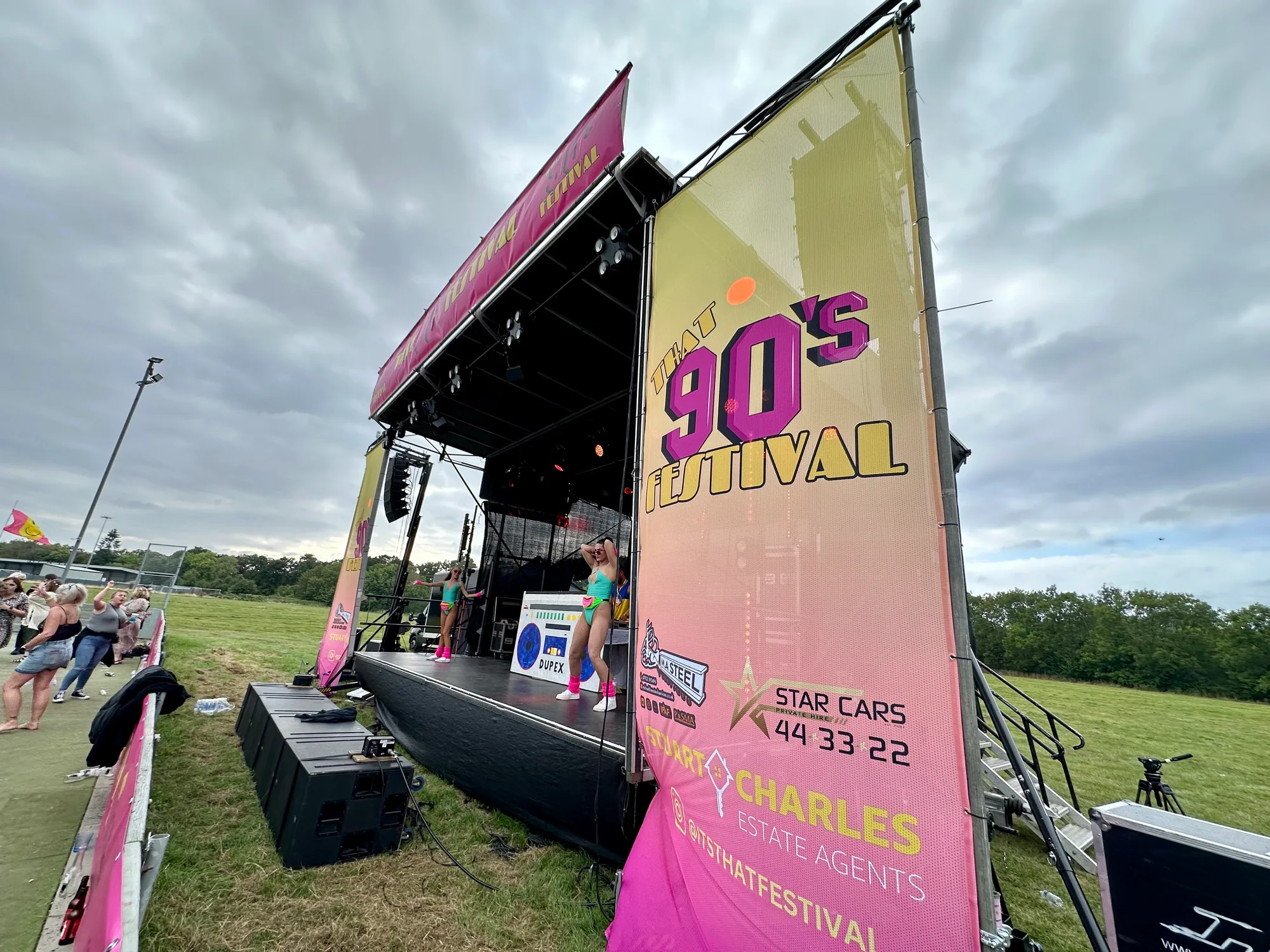 Close view of full-height side branding mounted beside the That's 90s Festival trailer stage