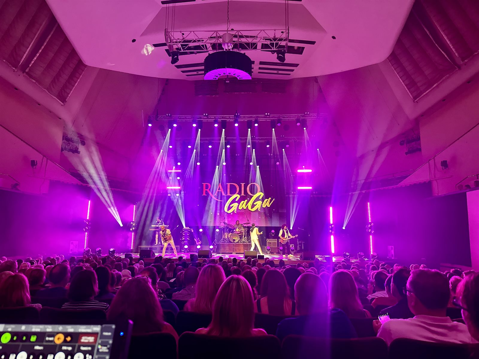 Live show lighting beams over an audience